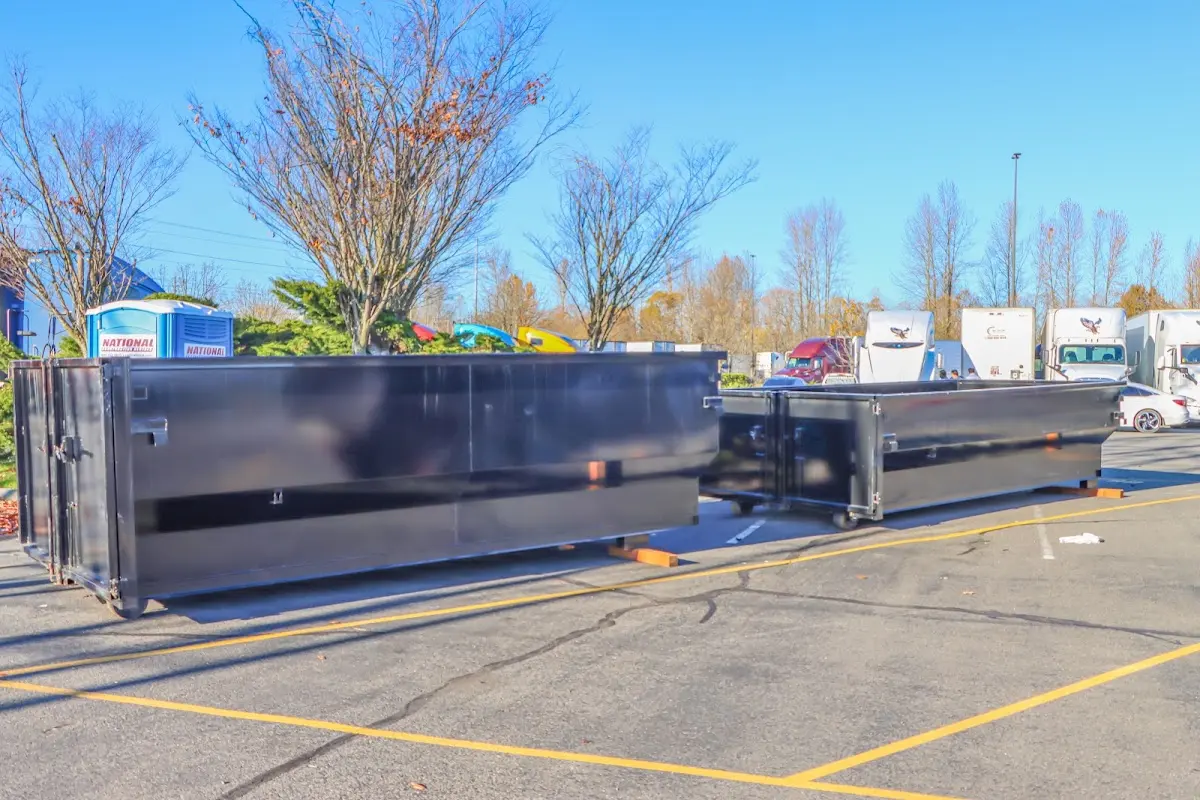 Professional dumpster rental service with roll-off container on residential driveway in North Kensington